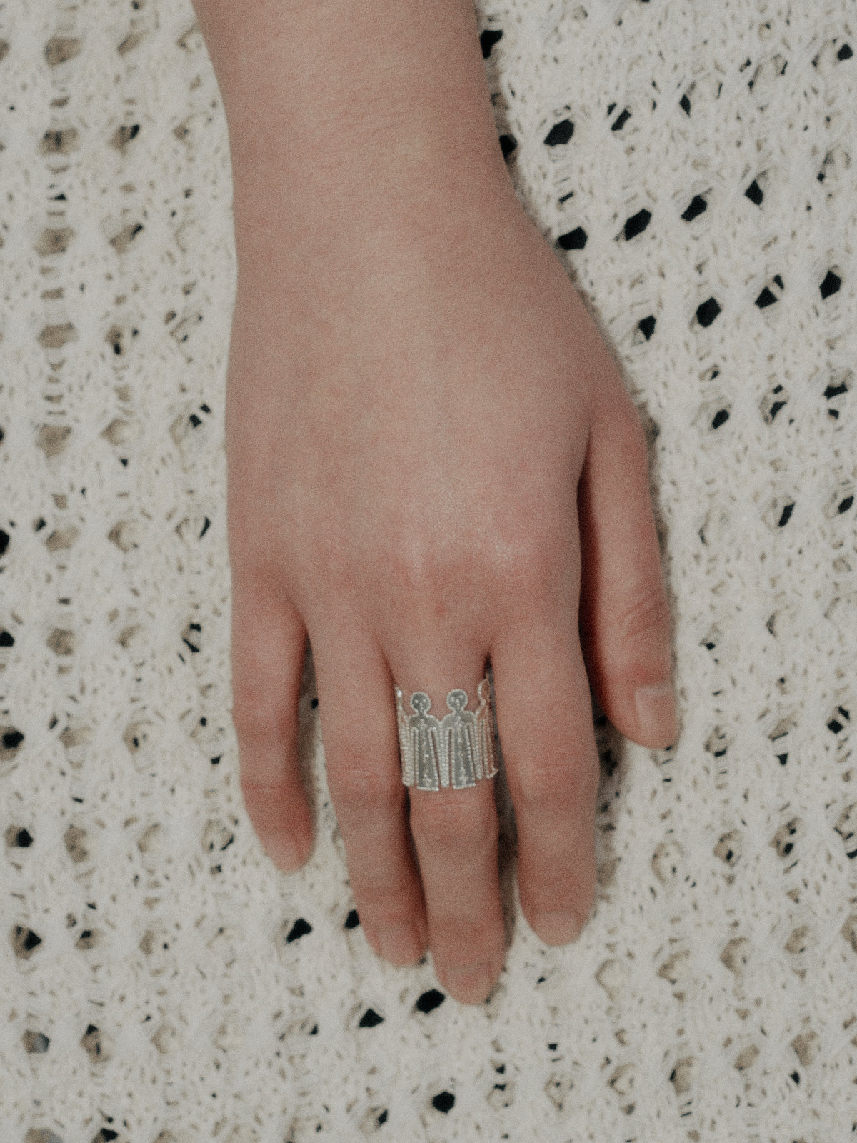 Silver Calm Man ring with a carved vertical centerpiece on a slim band
