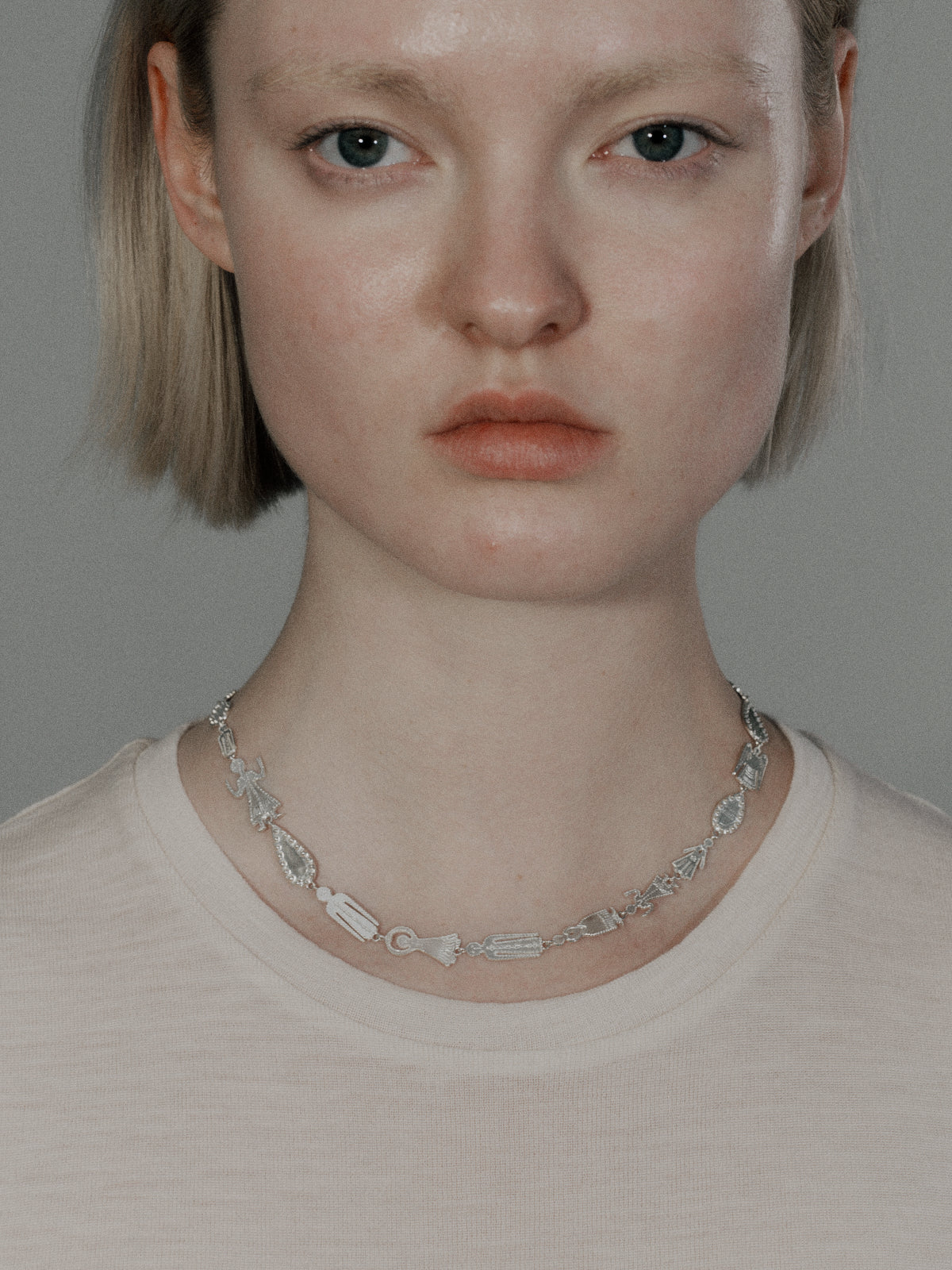 Silver ball link necklace with oval charms, stacked chain look at front