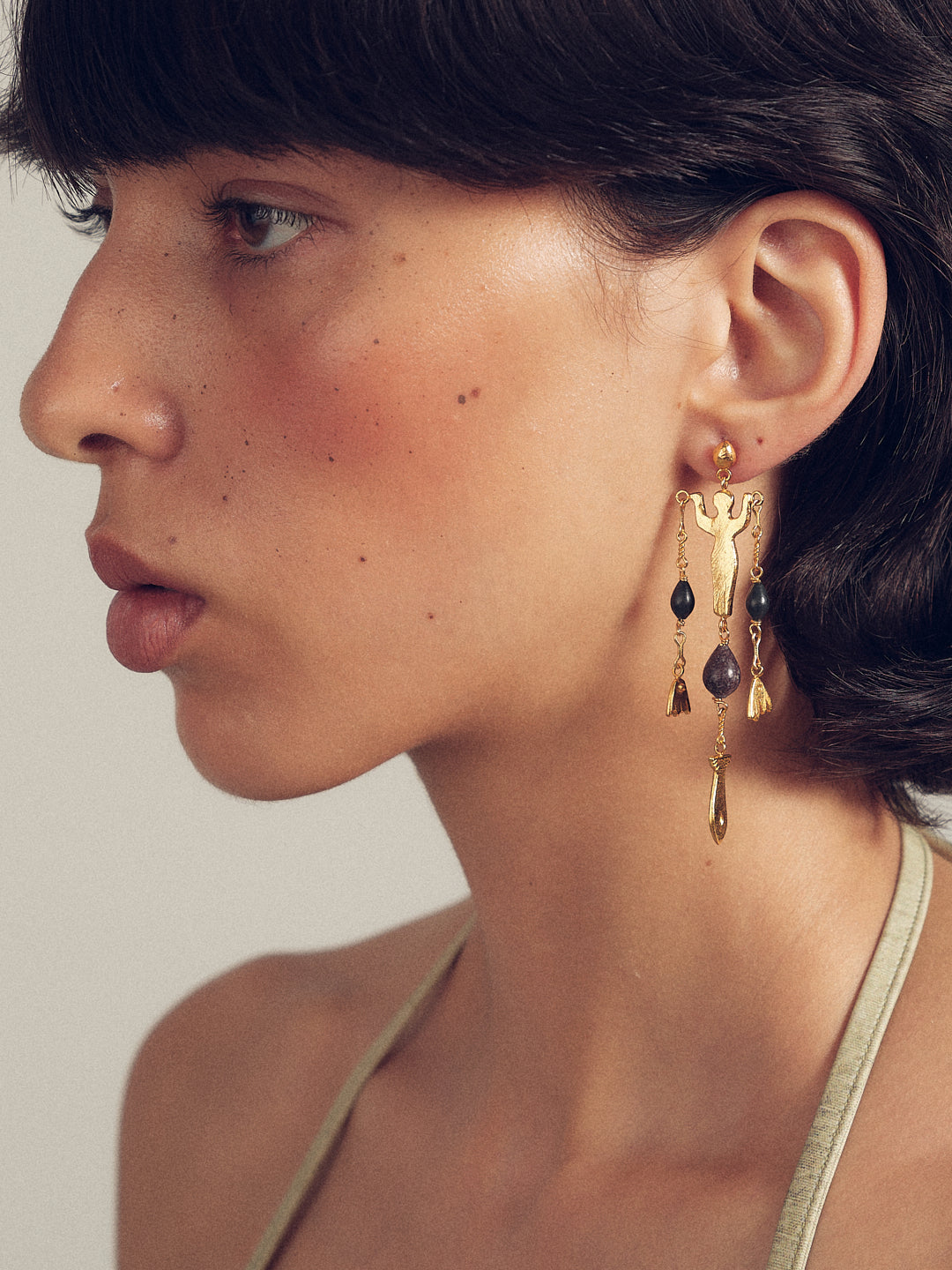 Gold-plated circus earrings with dangling navy bead charms and small hoop mounts