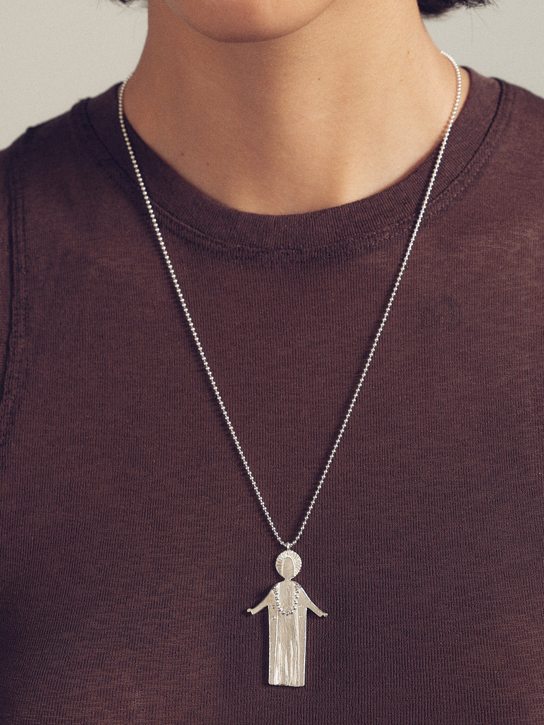 Silver chain necklace with detailed fairy figure charm pendant at center