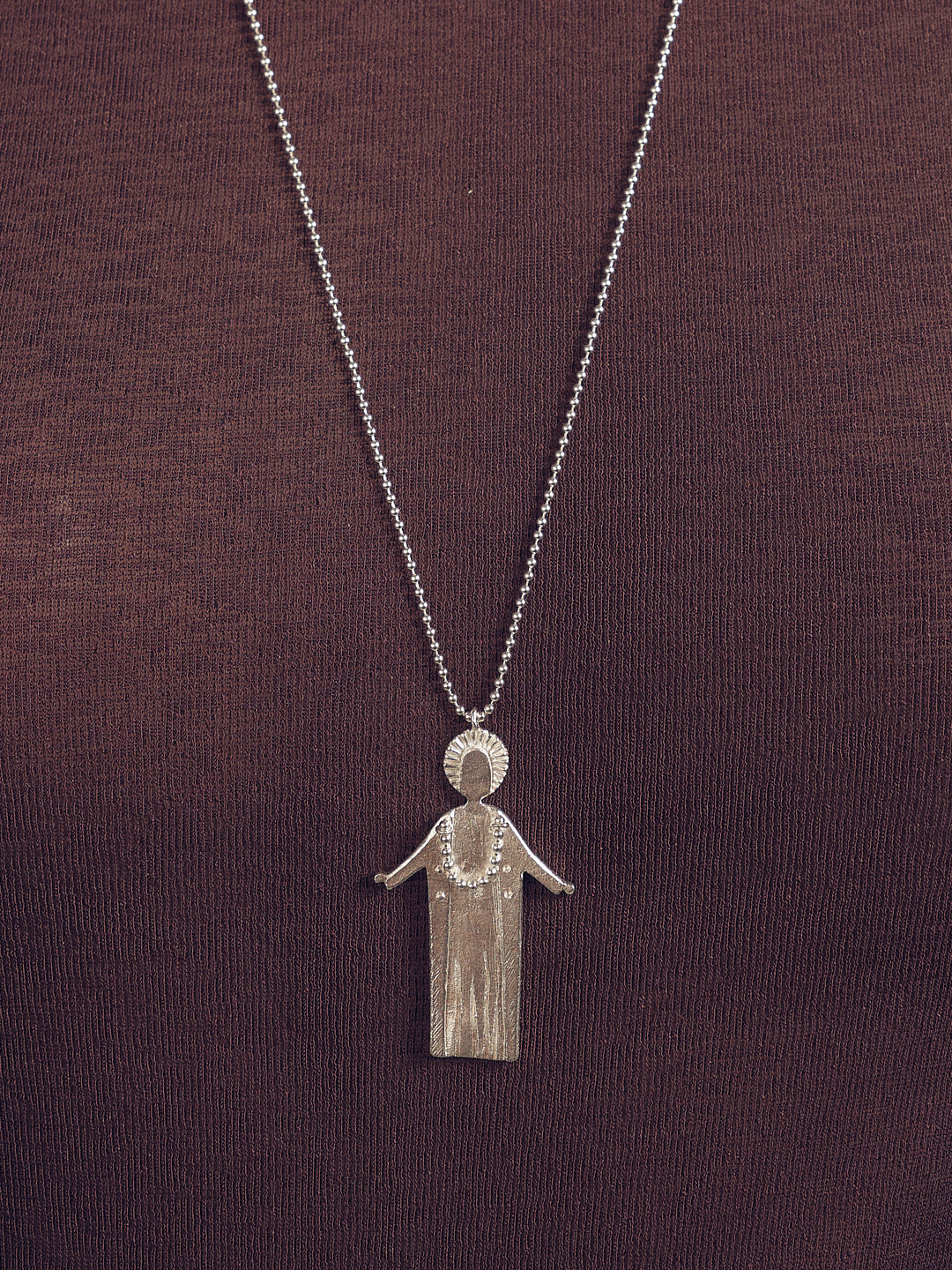 Silver fairy necklace with hanging pendant charm at center