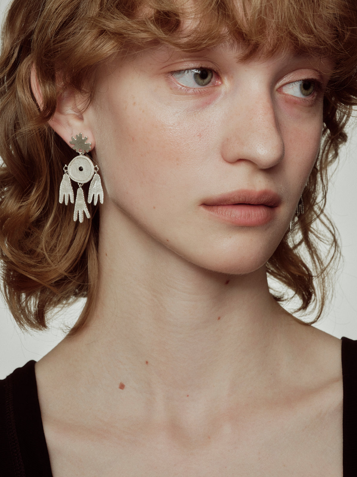 Silver dreamcatcher earrings featuring round center and dangling multi-piece drops
