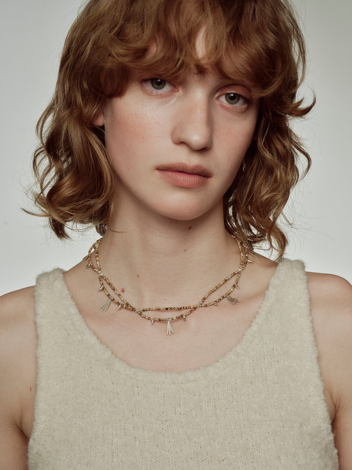 Picture Jasper footprint beaded necklace on model, layered beaded strands with footprint pendants