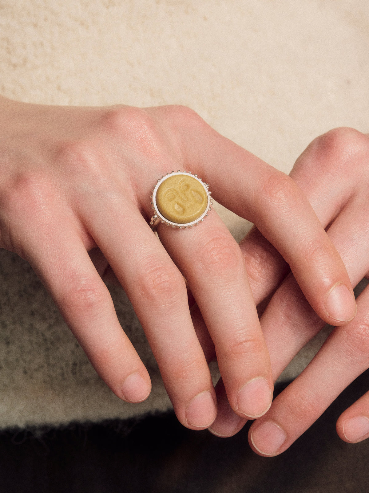 Yellow medallion wine tear drop ring in silver tone with detailed border on top view